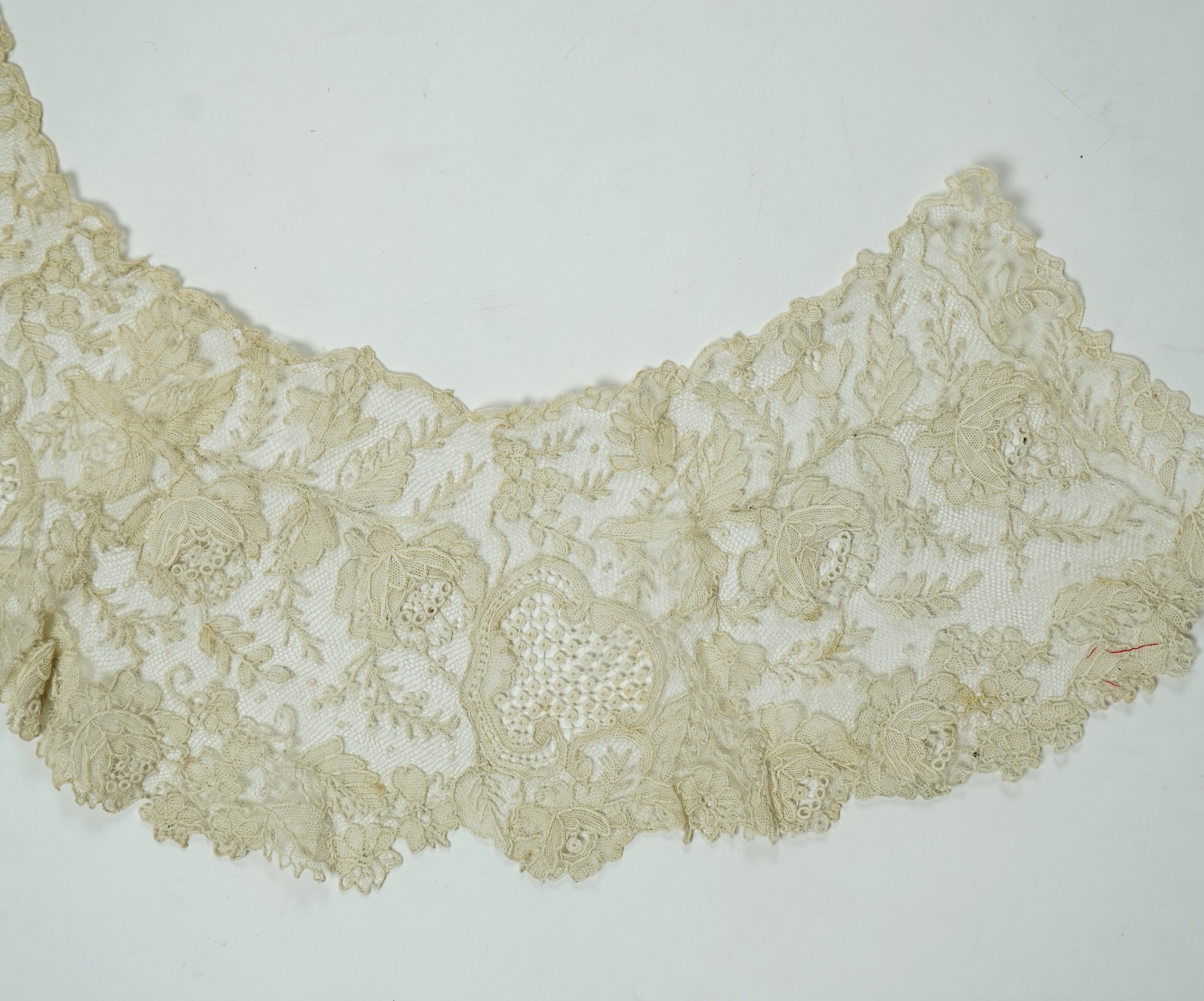 A 19th century Brussels Point de Gaz needle lace collar, lappet and wedding hankie, possibly part of a trousseau. The collar having thirty four needle lace raised flower heads within the design. The collar 100cm long x 1